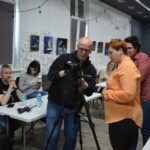 Michał Buksa pokazuje uczestniczkom obsługi aparatu