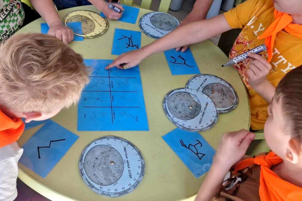 Dzieci odwzorowują gwiazdozbiory z rysunku i mapy nieba