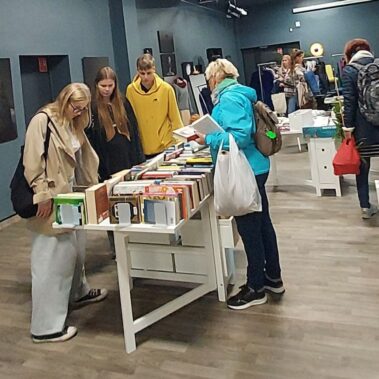 Goście przeglądają książki i ubrania