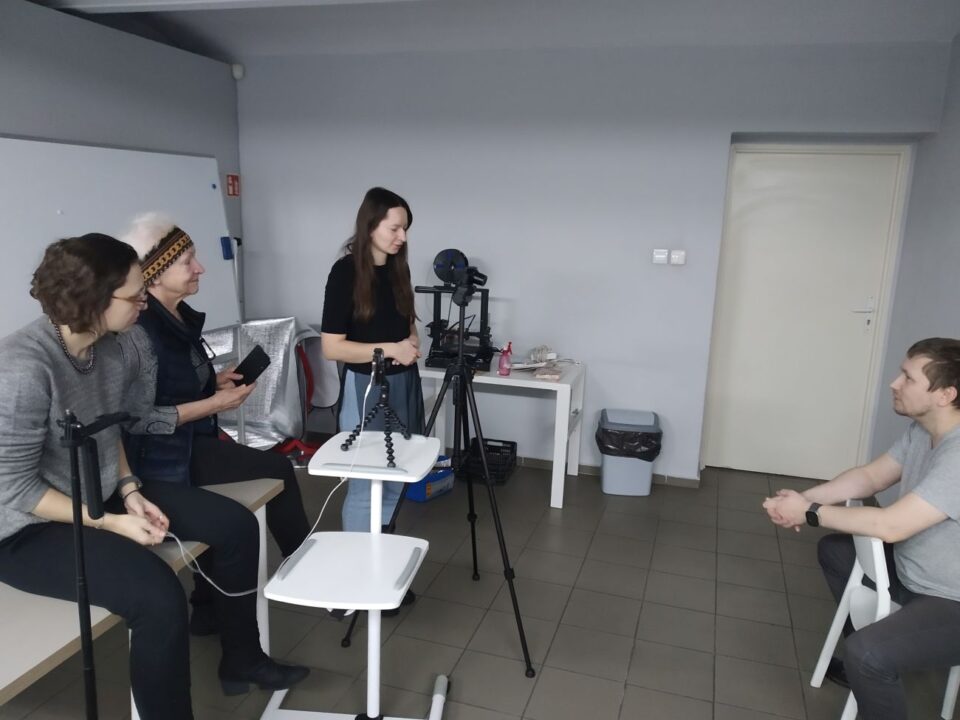 Uczestnicy dyskusją, model siedzi na krześle