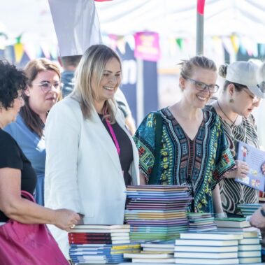 Prezydentka z dyrektorem i paniami odwiedzają stoisko biblioteczne