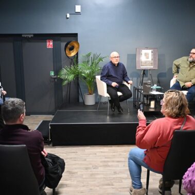 Konferansjerka wita gości na scenie siedzą dr. Sebastian Rosenbaum i dr. Bogusław Tracz